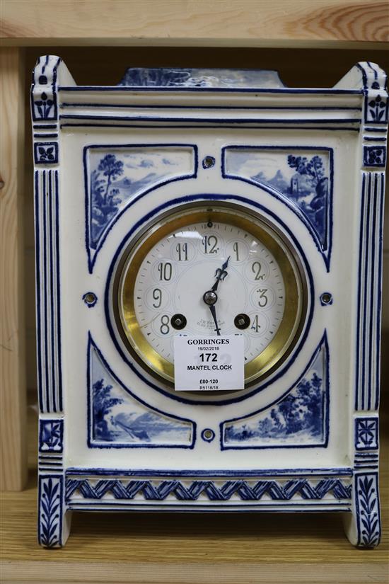 An Edwardian blue and white pottery mantel clock, with dial signed J.W. Benson, 29cm